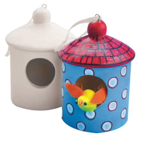 one white ceramic birdhouse and one painted red and blue with dots ceramic birdhouse