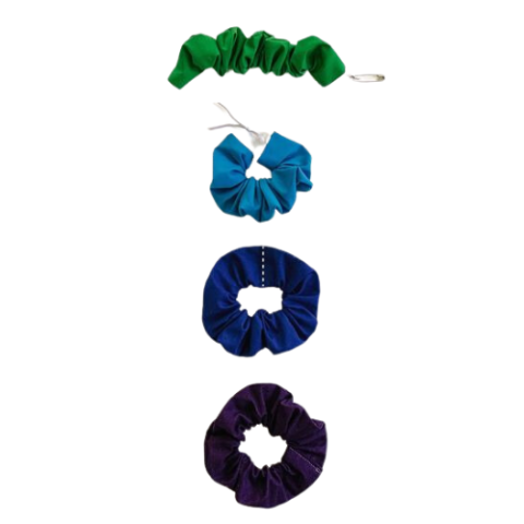four scrunchies in green, blue, purple, and black being made
