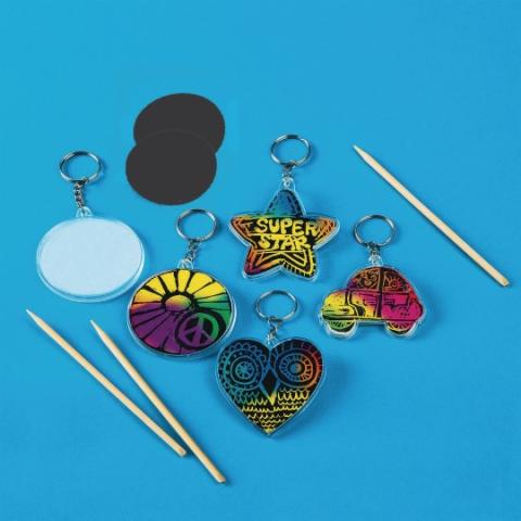 four brightly colored keychains on a blue background