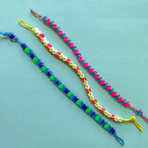 three striped bracelets on a blue background